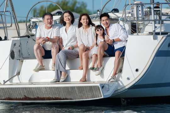 Happy family aboard a yacht out to sea