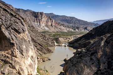 panoramic view of the Caucasus Mountains gorges ancient fortresses and curved mountain roads on a spring day taken from a drone