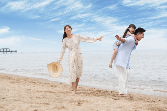Family of three playing on the beach