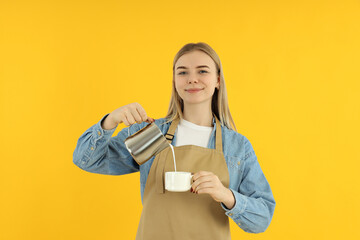 Obraz premium Concept of occupation, young barista on yellow background