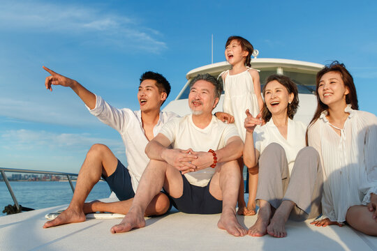 Happy family aboard a yacht out to sea