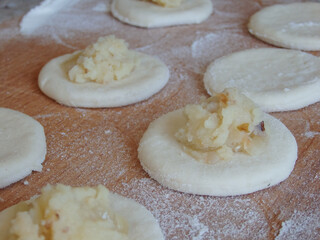 Cooking dumplings stuffed with yeast dough. Making traditional dumplings