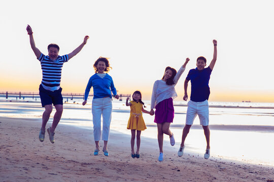Happy family playing on the beach