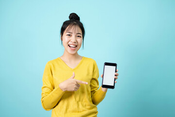 Young woman look camera and smiling as pointing smartphone display