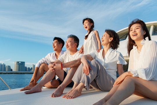 Happy family aboard a yacht out to sea
