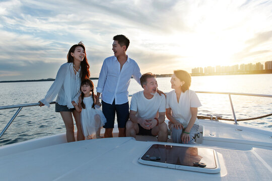 Happy family aboard a yacht out to sea