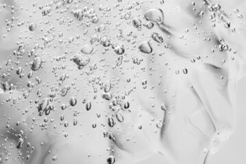 Close up macro Aloe vera gel cosmetic texture white background with bubbles. Lemongrass gel skincare product. antibacterial liquid with aloe vera, moisturizing. Serum texture. Hand sanitizer