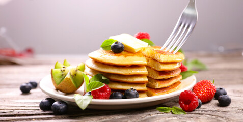 pile of pancakes and berries fruits