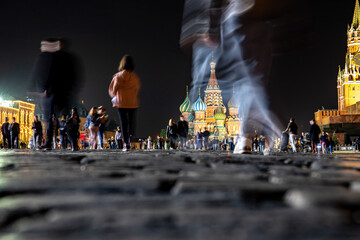 Basil's Cathedral and Spasskaya Tower on Red Square at night and people walking