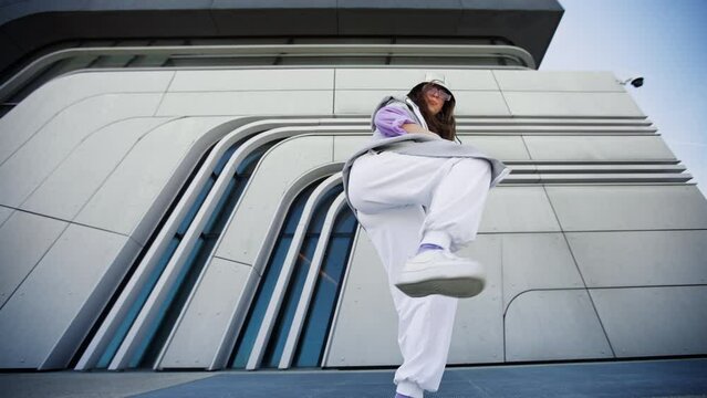 woman dancing on urban spat. Girl performing hip hop dance style having fun freestyle dancer in urban city