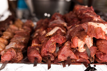 Miscellaneous meat on skewers, ready to be grilled.