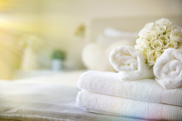 Set of clean white towels on bed