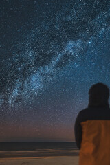A silhouette of a person in front of a universe constellation. Concept of outdoors night skies and...
