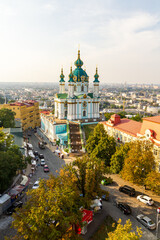 Fototapeta na wymiar Kyiv, Ukraine – August 12, 2014: Aerial view on historical St Andrew's Church. A beautiful panorama of Podil area. 