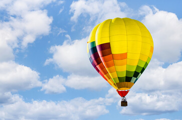 Colorful hot air balloon flying over blue sky