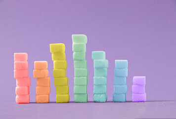 Sugar cubes on a purple background. . Junk food concept