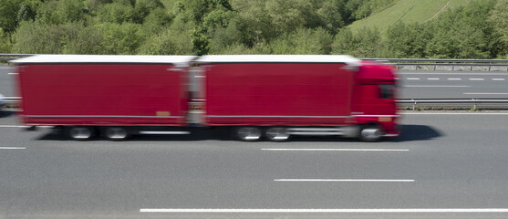 Red truck driving on the highway