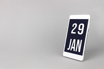 January 29th. Day 29 of month, Calendar date. Smartphone with calendar day, calendar display on your smartphone. Winter month, day of the year concept.
