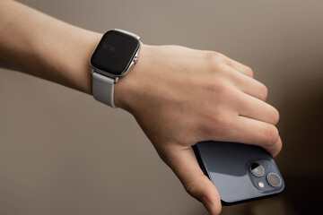 Hand with smart watch. The flagship smartphone is in the hand.