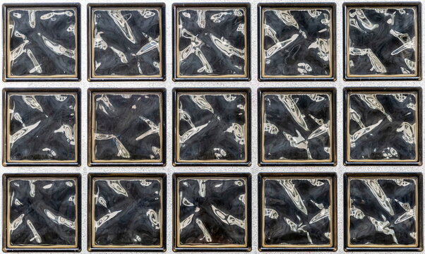 Pattern wall of small dark square glass blocks as background