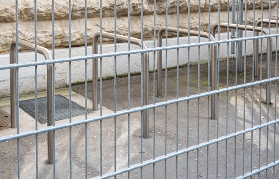 Secured parking for bikes and bicycles with a fence