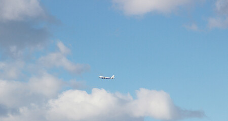 Naklejka na ściany i meble Silhouette of a passenger plane against a clear sky