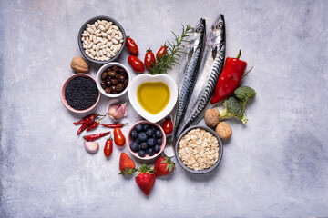 on the textured background, variety of Mediterranean healthy foods based on legumes, fish,...