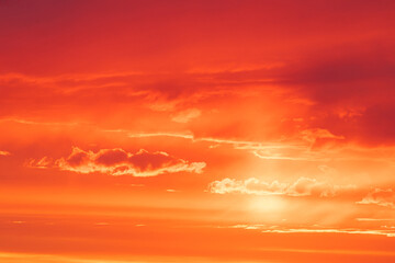 Vivid, bright and colorful background of red, orange and yellow morning or evening sky during sunrise or sunset