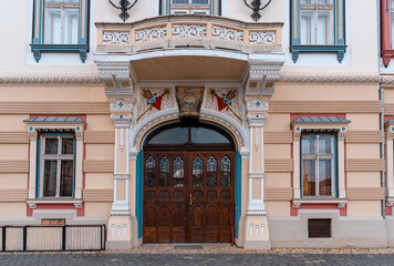 Fototapeta premium Beautiful antique arch wooden door entrance in the city square