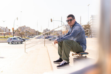 Adult man sitting on stairs in the city