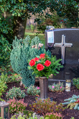 Facemask lying on grave of family members with a facemask during the pandemic