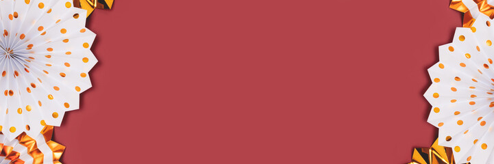 Banner with border frame made of paper fans. White and gold decorations on a red background.