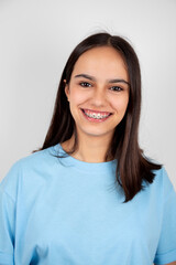 Portrait of a cute and happy teen girl with braces smiling