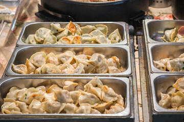 Chinese pan fried dumplings, potstickers, on display at Brick Lane Market in London, England