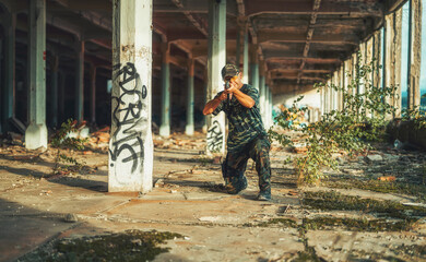 Airsoft hand in the hand industry building.