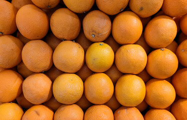 Close up of fresh oranges fruits at stall of supermarket in Asia. Healthy and delicious diet. Flat lay.