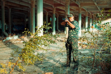 Airsoft hand in the hand industry building.