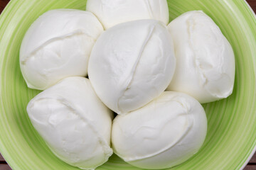 Buffalo mozzarella (mozzarella di bufala) on the plate. Flat lay. Close-up. Mozzarella from Campania DOP.