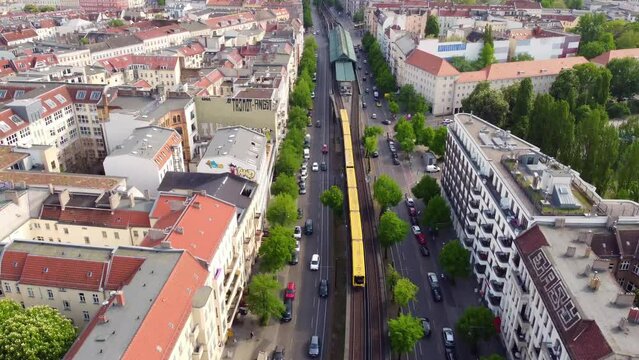 public transport in the city U bahn leaves station Eberswalder Spectacular aerial view flight track from above drone footage of Berlin Prenzlauer Berg Sch&ouml;nauer Allee 2022 Cinematic by Philipp Marnitz