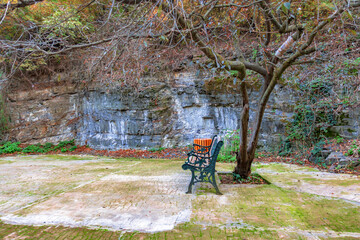 Street benches in a picturesque place of the park near the hill