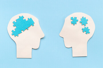 Communication. Chaos and peace in brain - two paper human heads with puzzles