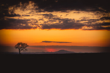 Fototapeta na wymiar Beautiful sunset on rural landscape.Mountains in background.