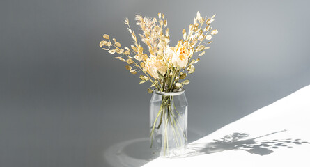 Withered flowers bouquet in plastic bottle to reduce waste. Beautiful dried flowers aesthetic and eco friendly home decor.
