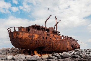 Plassey shipwreck on shore of Inisheer island. Aran islands, county Galway, Ireland. Rough stone...