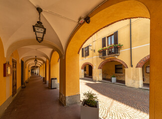 Caramagna Piemonte, Piedmont, Italy - May 10, 2022: Ancient historical arcades in via Luigi Ornato
