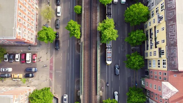 Camera tracks cars and streetcar, ends with a panorama of the TV tower Great aerial view flight tilt up drone footage of Berlin Prenzlauer Berg Schönauer Allee Spring 2022 Cinematic by Philipp Marnitz