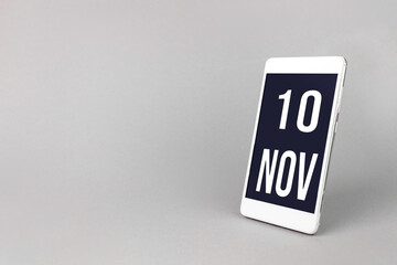 November 10th. Day 10 of month, Calendar date. Smartphone with calendar day, calendar display on your smartphone. Autumn month, day of the year concept.