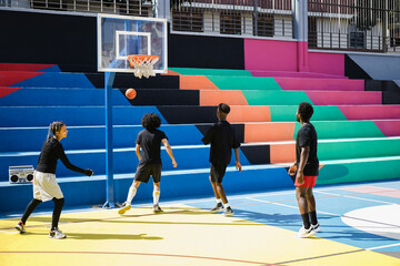 African friends playing basketball outdoor - Focus girl face
