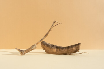 Abstract minimalistic scene made of dry tree branches. Natural wooden podium on beige background. Concept natural cosmetics with organic components. Showcase, display case