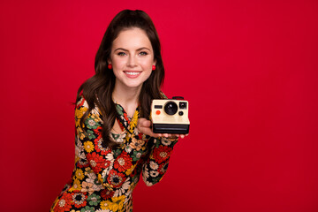 Portrait of attractive cheerful girl holding old fashioned cam making capture cadre isolated over...